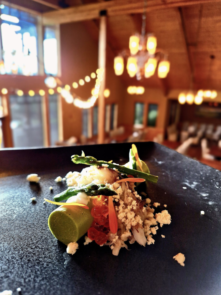 A plated course in a warmly lit dining room
