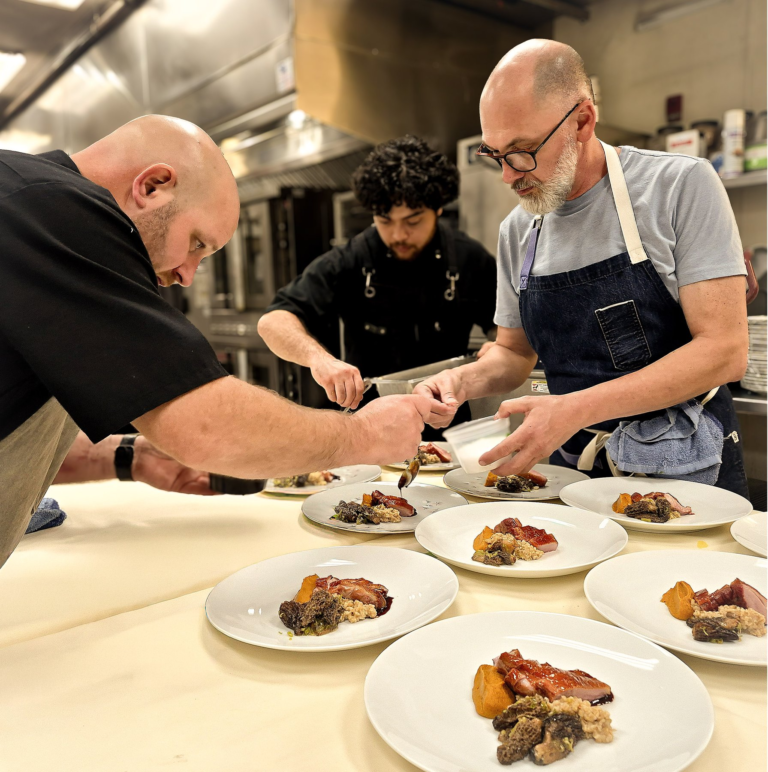 Gary Shelly, at left, plating with the kitchen team at Spring Supper